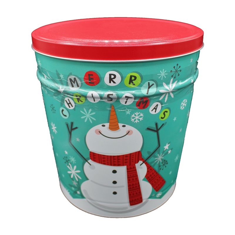 mint green popcorn tin with a red lid. depicting a cartoonish winter snow flurry. with a jolly snow man smiling and looking above it's head at the words merry Christmas spelled out with each letter on a Christmas bulb ornament